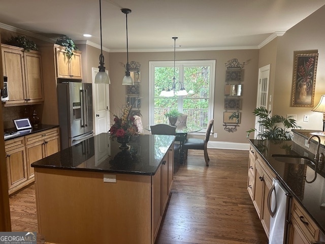 kitchen with sink, hanging light fixtures, dark hardwood / wood-style floors, a kitchen island, and stainless steel appliances