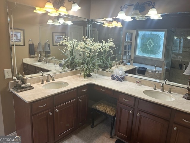 bathroom with tile patterned flooring, vanity, and walk in shower