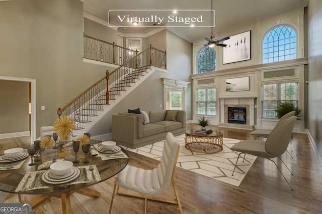 living room featuring a high ceiling, plenty of natural light, and hardwood / wood-style floors