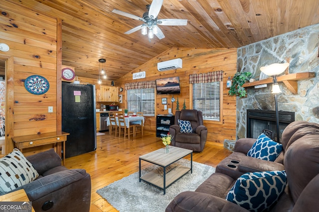 living room with wood ceiling, a wall mounted AC, light hardwood / wood-style flooring, and wood walls