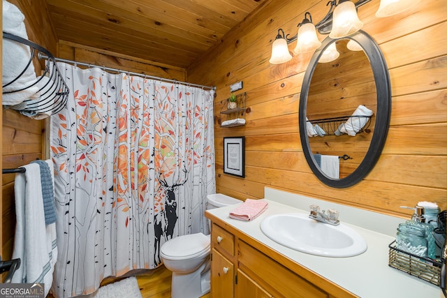 bathroom featuring toilet, vanity, wood ceiling, and wooden walls