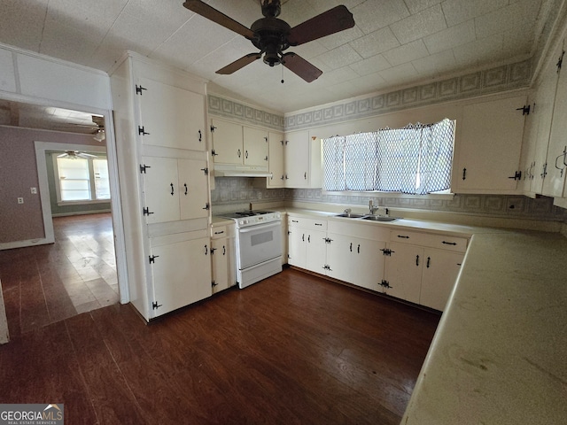 kitchen featuring white cabinetry, sink, dark hardwood / wood-style flooring, white range, and backsplash