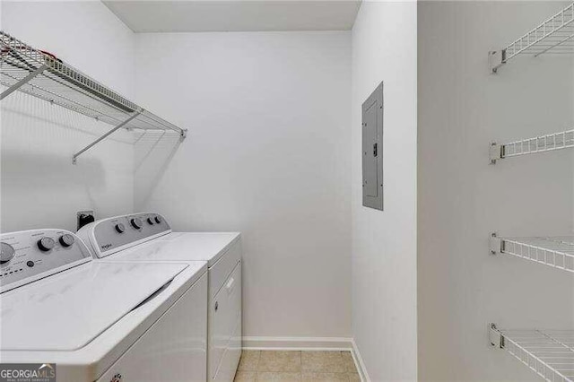 clothes washing area featuring light tile patterned floors, separate washer and dryer, and electric panel