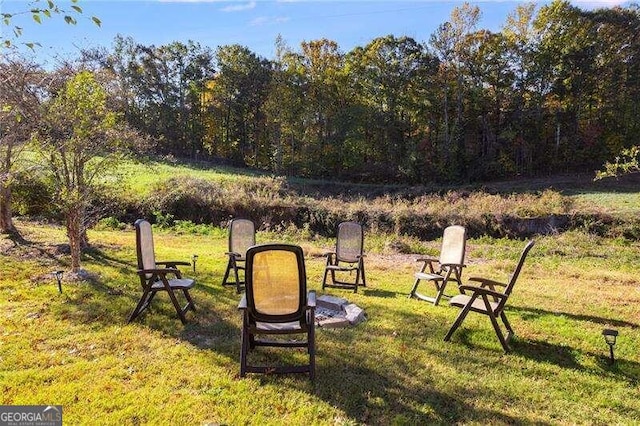 view of yard featuring an outdoor fire pit