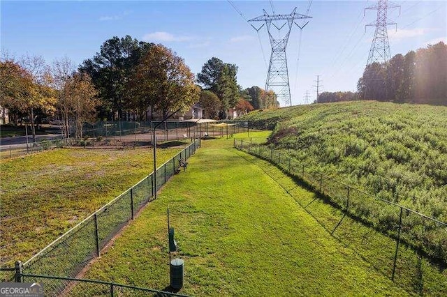 surrounding community with a rural view and a yard