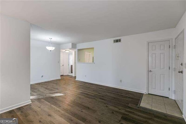 empty room featuring dark hardwood / wood-style flooring