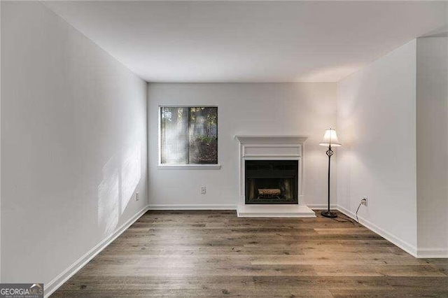 unfurnished living room with dark hardwood / wood-style floors