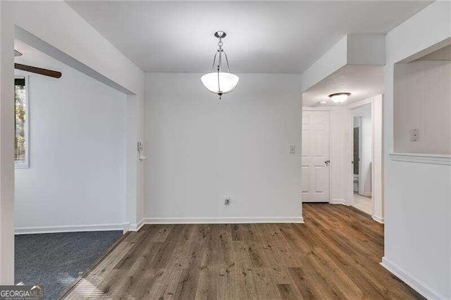 unfurnished dining area with dark hardwood / wood-style flooring