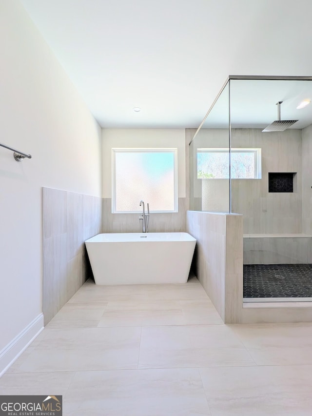 bathroom with separate shower and tub and tile patterned floors