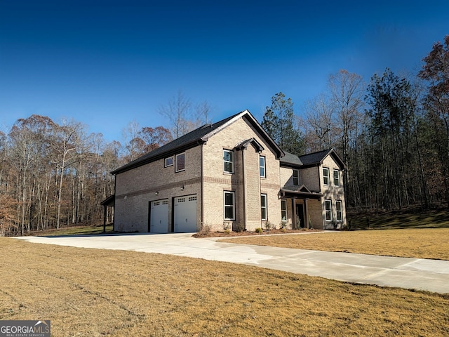 front of property with a front lawn and a garage