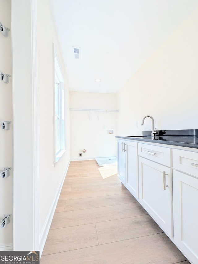 bathroom with hardwood / wood-style flooring and sink