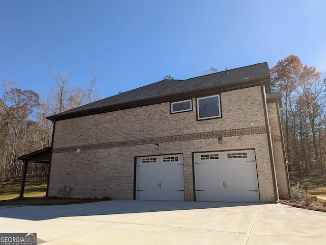 view of side of home featuring a garage