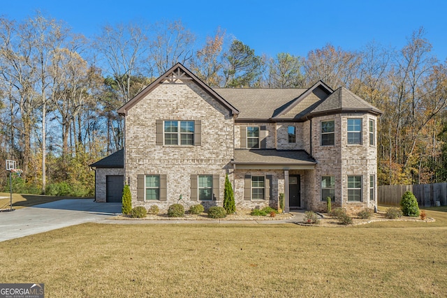 view of front of house with a garage and a front lawn