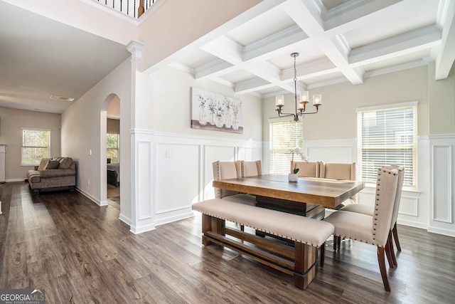 dining room featuring a healthy amount of sunlight, dark hardwood / wood-style flooring, beam ceiling, and coffered ceiling