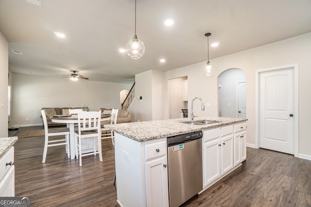 kitchen featuring dishwasher, white cabinetry, a kitchen island with sink, and sink