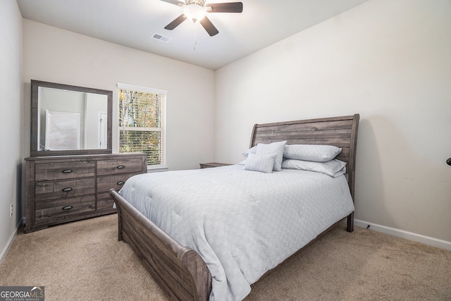 bedroom with ceiling fan and light colored carpet