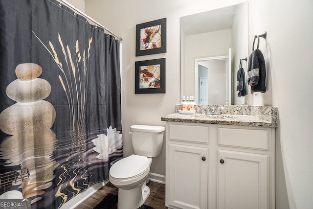 bathroom with hardwood / wood-style floors, vanity, and toilet