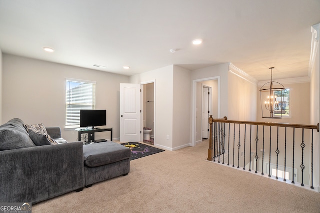 carpeted living room featuring a chandelier and crown molding