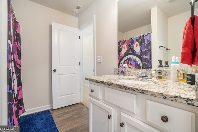 bathroom featuring hardwood / wood-style floors and vanity