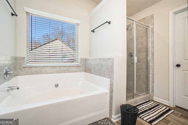 bathroom featuring plus walk in shower and hardwood / wood-style floors