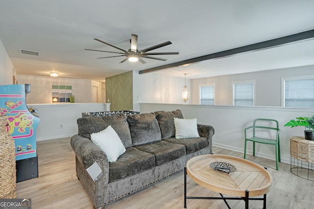 living room featuring ceiling fan and light hardwood / wood-style floors