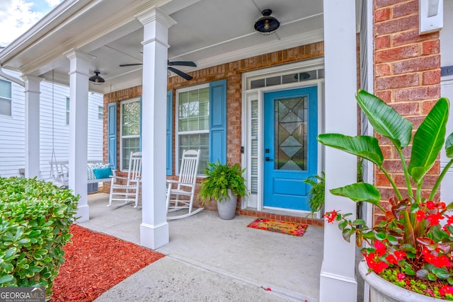 doorway to property featuring ceiling fan and a porch