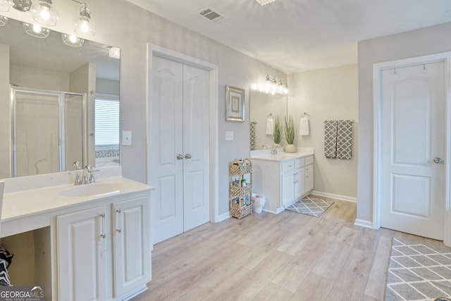 bathroom featuring wood-type flooring, vanity, and shower with separate bathtub