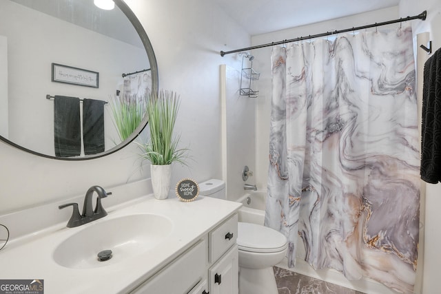 full bathroom with vanity, shower / tub combo, and toilet