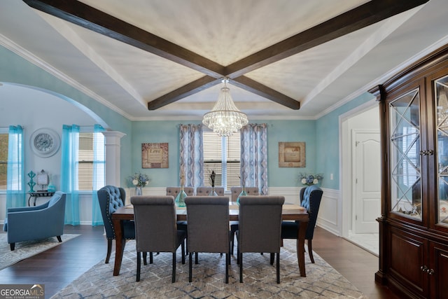 dining room featuring dark hardwood / wood-style flooring, plenty of natural light, beamed ceiling, and a notable chandelier