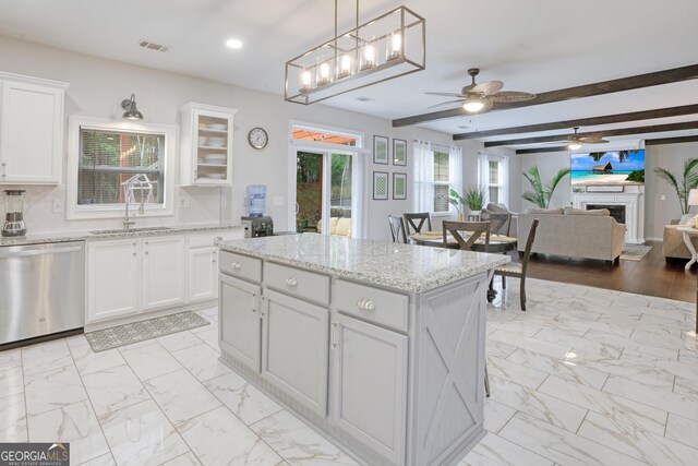 kitchen with beam ceiling, dishwasher, sink, decorative light fixtures, and white cabinets