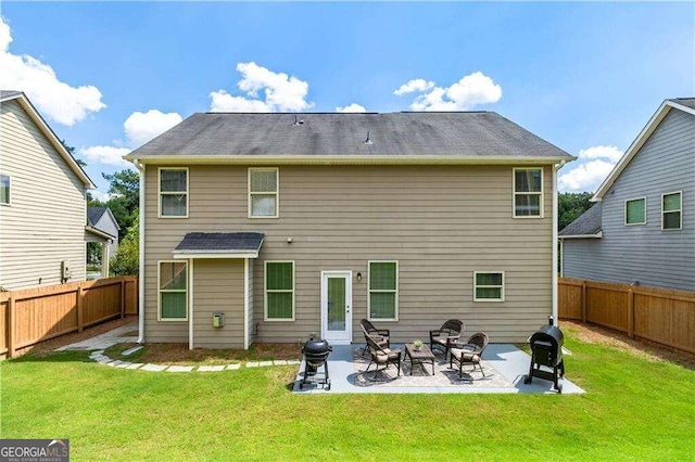 rear view of house featuring a patio area and a yard