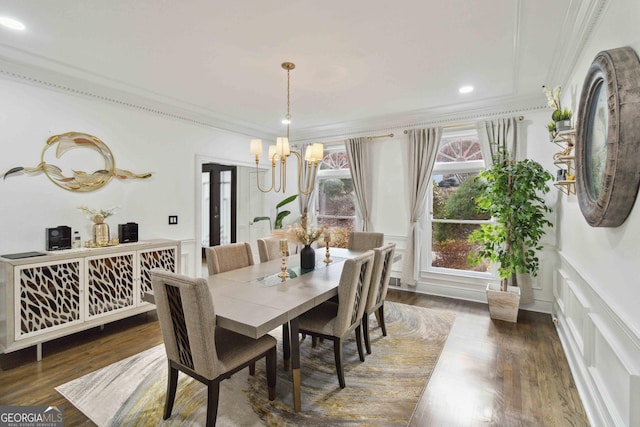 dining room with ornamental molding, a chandelier, and dark hardwood / wood-style floors