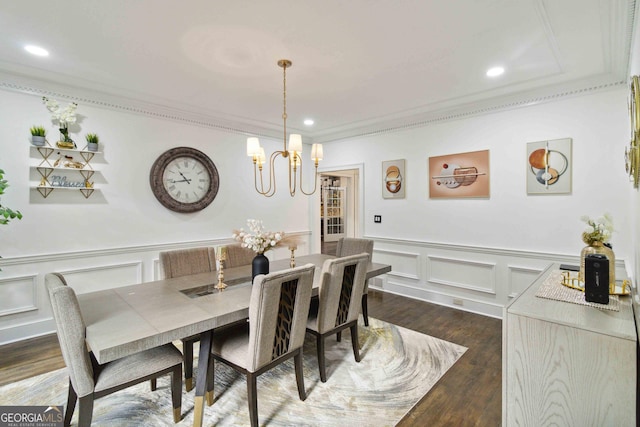 dining room with dark hardwood / wood-style flooring, crown molding, and a notable chandelier