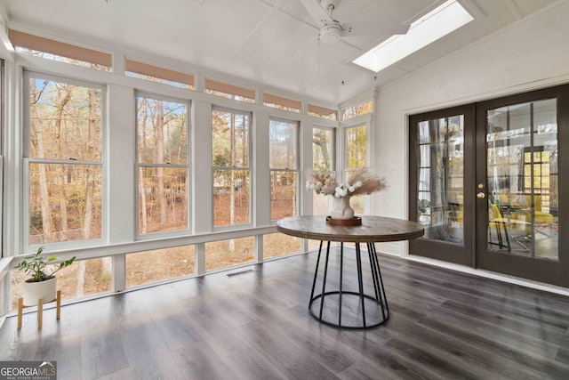 sunroom with vaulted ceiling with skylight and french doors