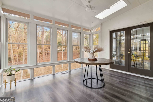 living room with beamed ceiling, a healthy amount of sunlight, ornamental molding, and dark wood-type flooring