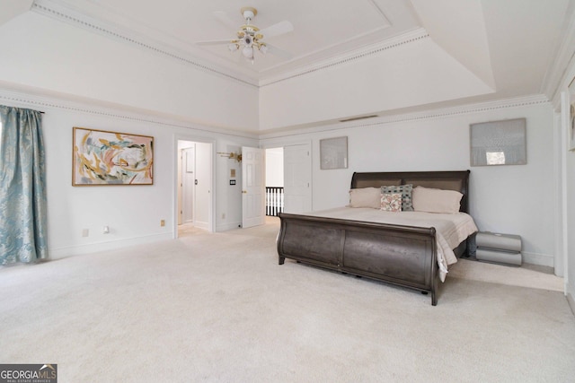 bedroom with a tray ceiling, ornamental molding, carpet flooring, and ceiling fan