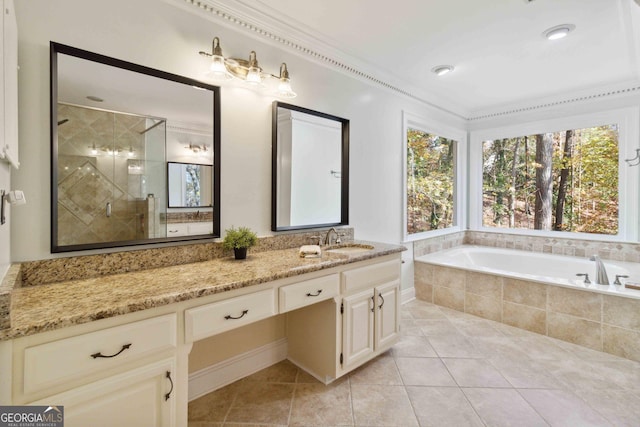 bathroom featuring plus walk in shower, vanity, and tile patterned flooring