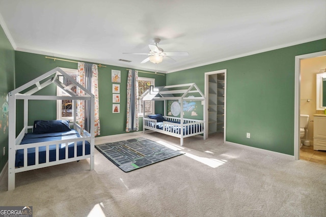 unfurnished bedroom featuring ceiling fan, carpet floors, crown molding, and ensuite bath