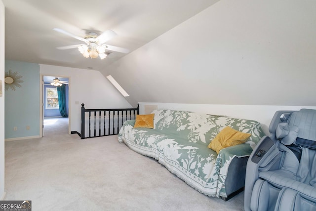 interior space featuring ceiling fan, lofted ceiling, and light carpet