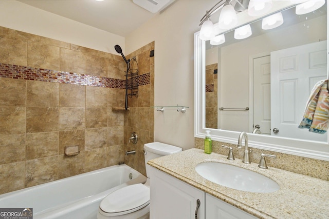 full bathroom with tiled shower / bath combo, vanity, and toilet