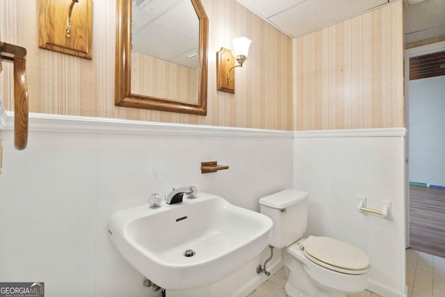 bathroom featuring sink, toilet, and tile patterned floors