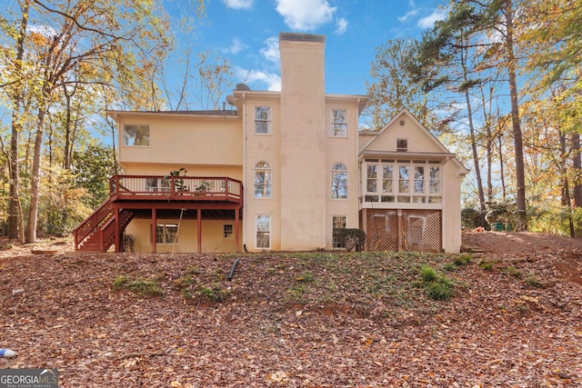 rear view of house featuring a deck and a sunroom