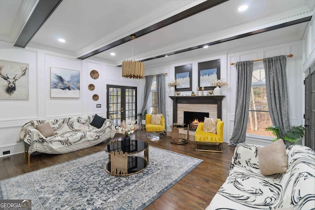 living room with a fireplace, french doors, beamed ceiling, crown molding, and dark hardwood / wood-style floors