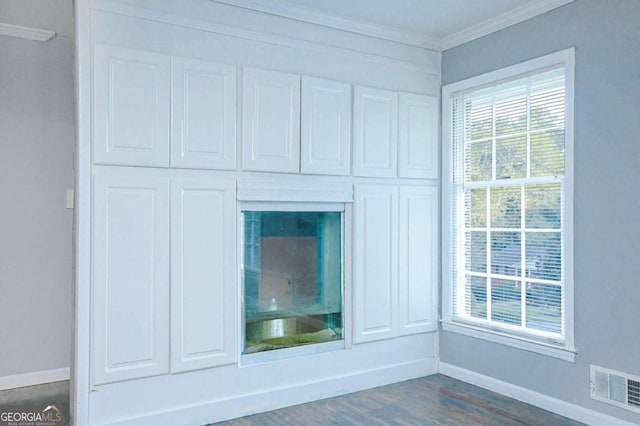 room details with hardwood / wood-style flooring and ornamental molding