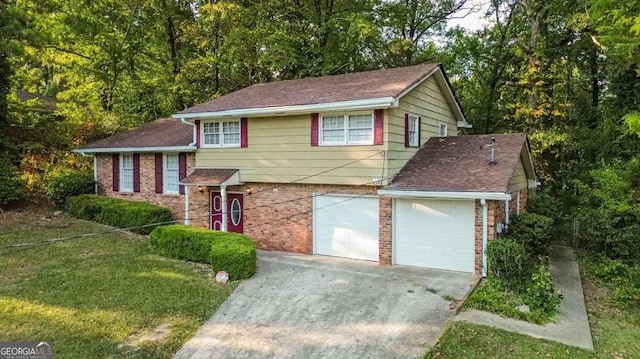 tri-level home featuring a front yard and a garage