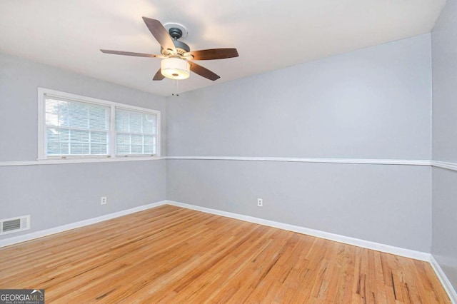 spare room with wood-type flooring and ceiling fan