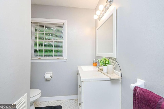 bathroom featuring vanity and toilet