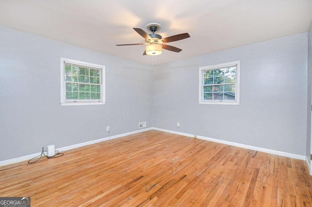 spare room featuring light hardwood / wood-style flooring and ceiling fan