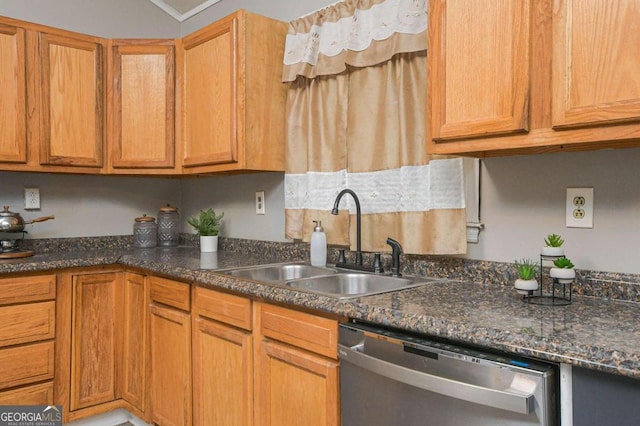 kitchen featuring dark stone countertops, crown molding, sink, and stainless steel dishwasher