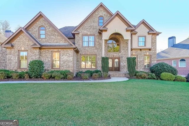 view of front of house with french doors and a front yard